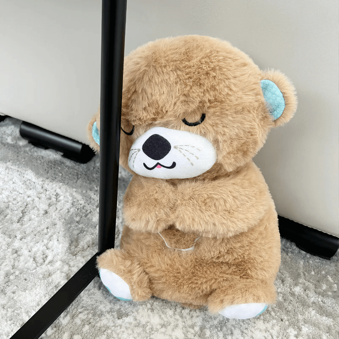 Front view of a brown Calming Otter dog toy positioned slightly behind a table foot, designed to soothe dog separation anxiety.